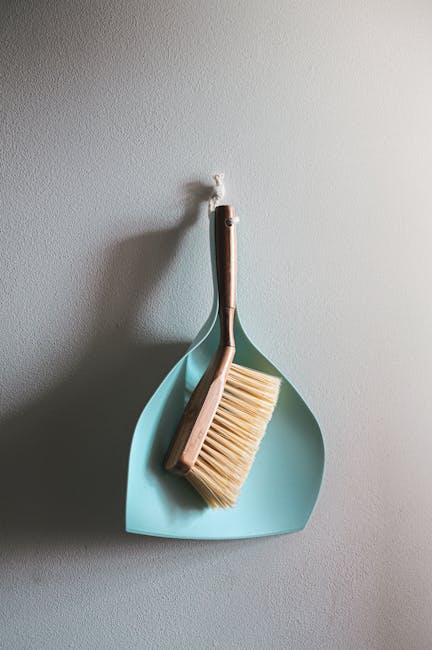 A team of three professional cleaners from cleanersse11.co.uk is conducting surface cleaning and deep cleaning in a modern residential living room. The cleaners are dressed in uniform and equipped wit